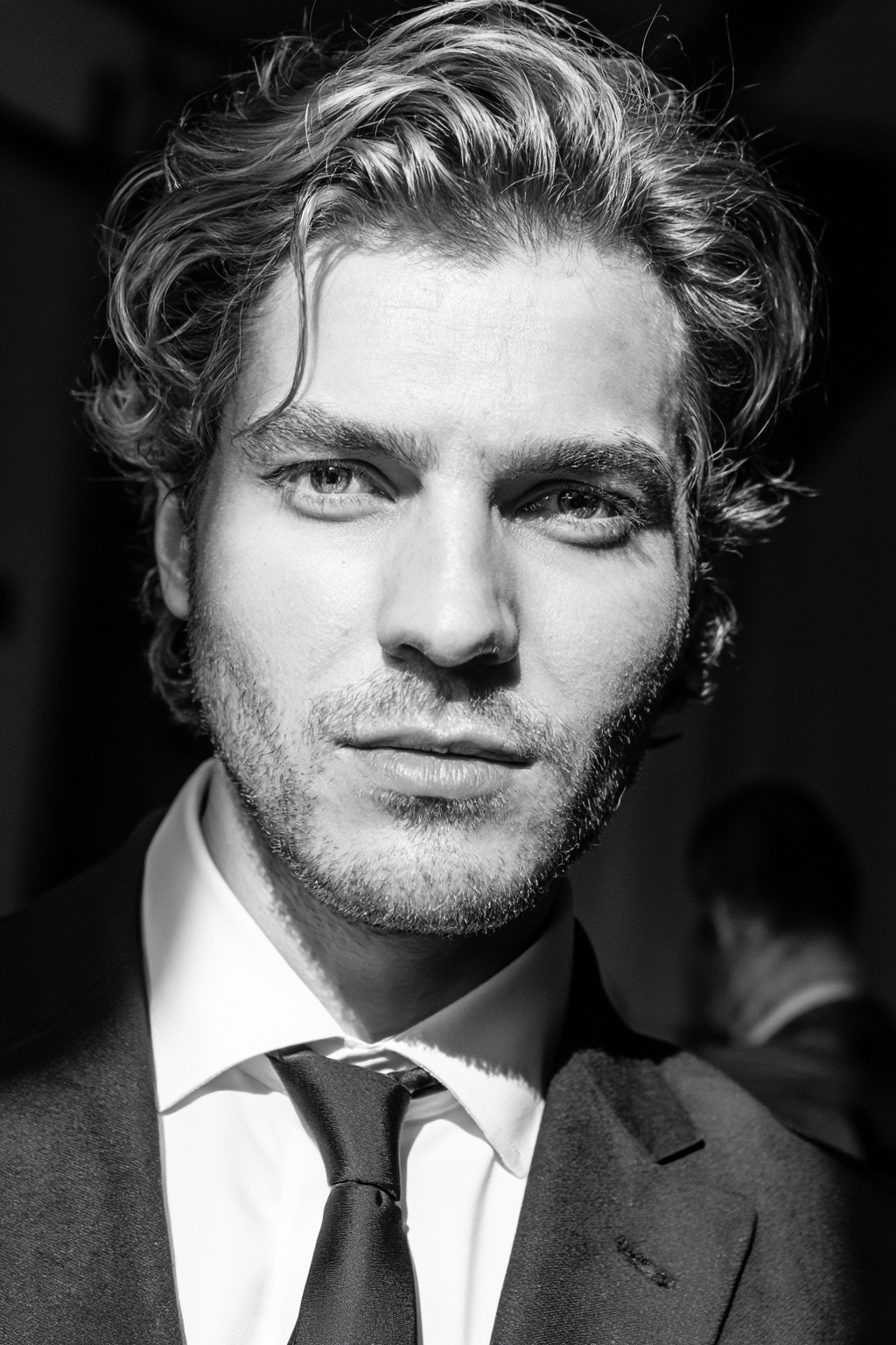 Black-and-white close-up of a man with wavy